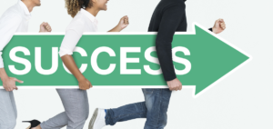 business people carrying a success sign