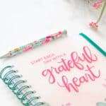 1grateful heart journal and floral pen on a white