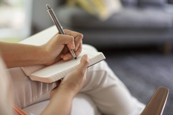a person writing and wondering Does A Gratitude Book Really Work?