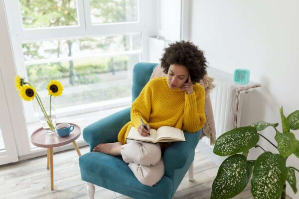 person writing and thinking What Are Some Questions to Ask Your Future Self?