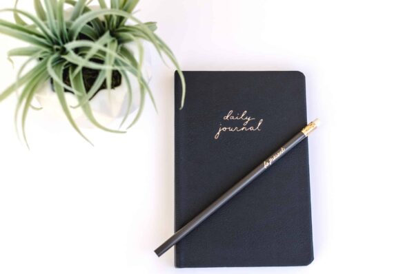 a pen and daily journal used for future self journaling