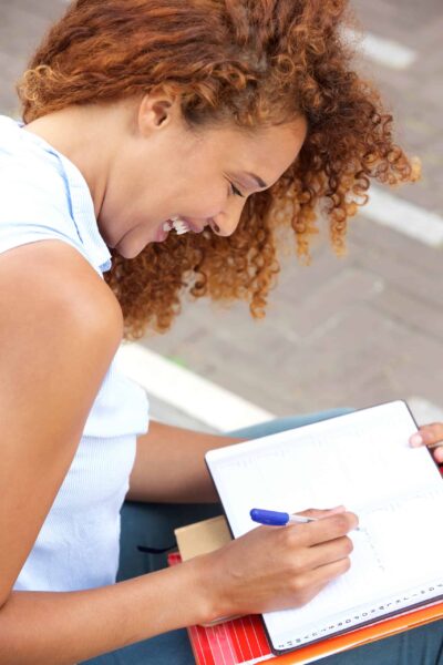 person journaling with mental wellbeing in mind