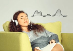 person slouched on lounge absorbed by listening to binaural beats sleep music