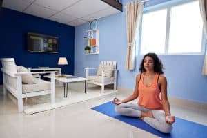 How long should I meditate - young lady meditating on her room