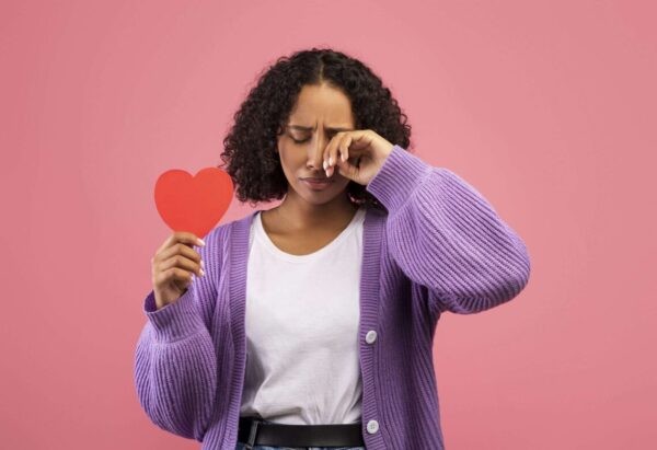 person crying thinking what happens when heart chakra energy is broken