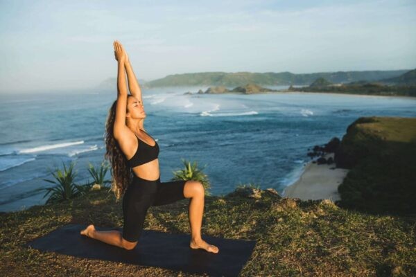 person doing yoga on the ocean rocks getting to know their chakras