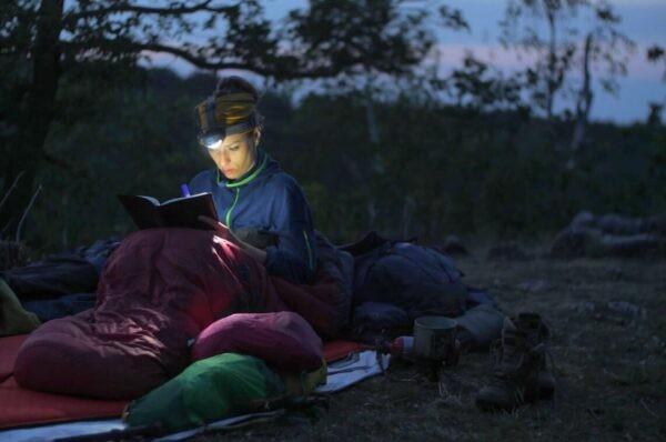 person outdoors at night reading how to unblock throat chakra