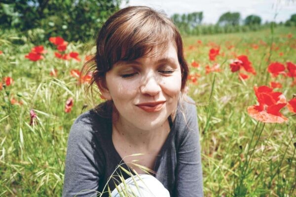 person enjoying outdoors near grass and flowers
