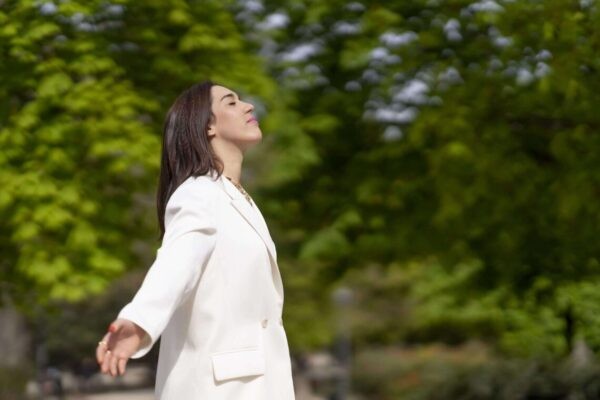 person taking a nice deep breath outdoors in nature