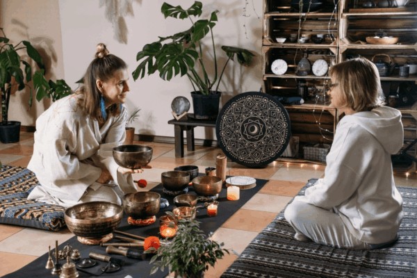 person explaining what a sound bath is to someone