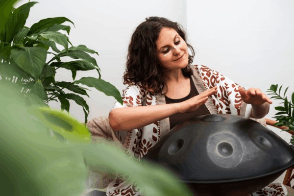 person playing hang drum