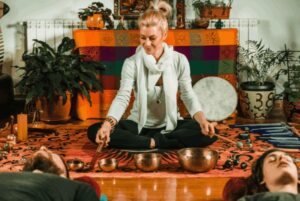 person playing meditation instruments for a sound bath experience