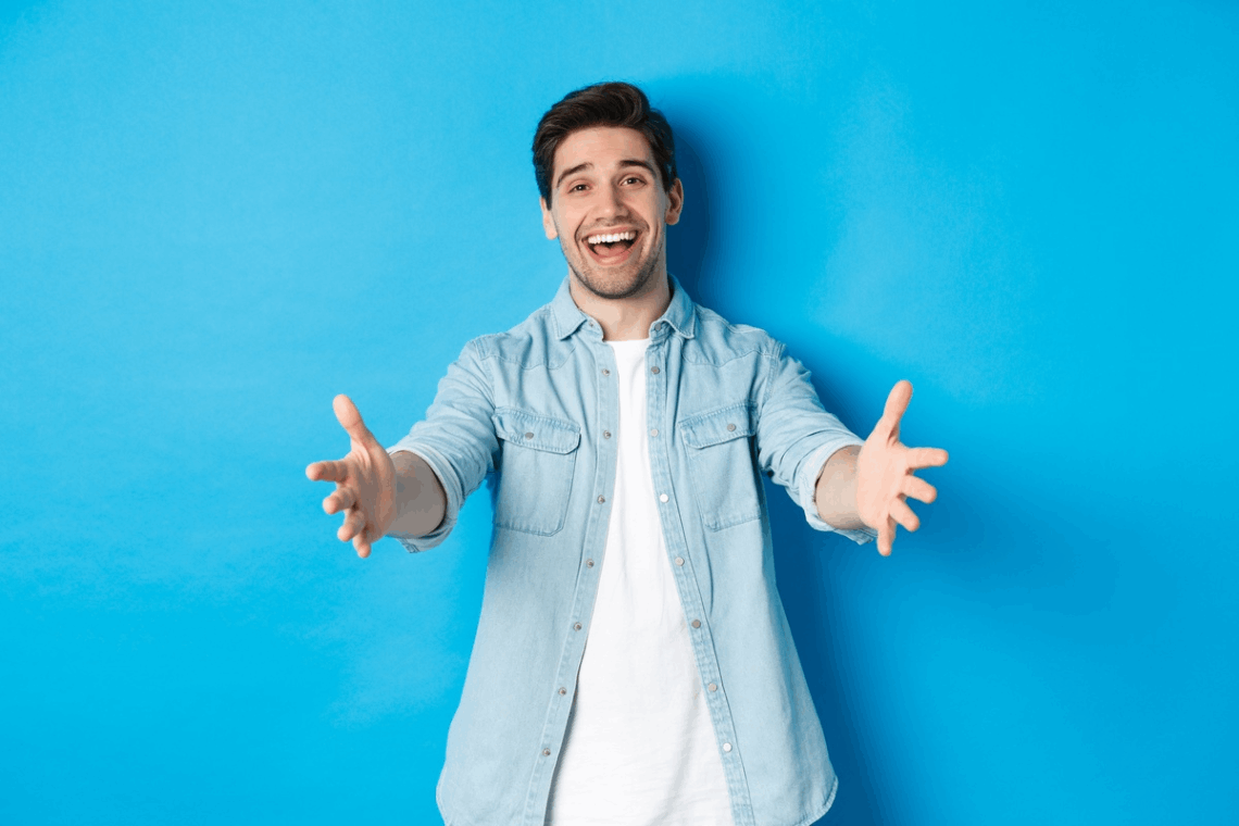 Friendly and positive man with welcoming arms