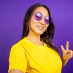 Person showing peace sign to have a positive day
