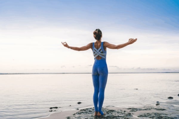 person on beach saying throat chakra affirmations