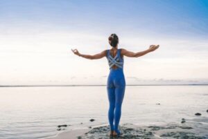 person on beach saying throat chakra affirmations