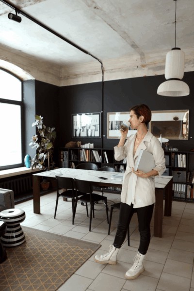 person in office drinking coffee