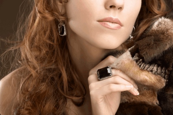 person wearing a black gemstone ring