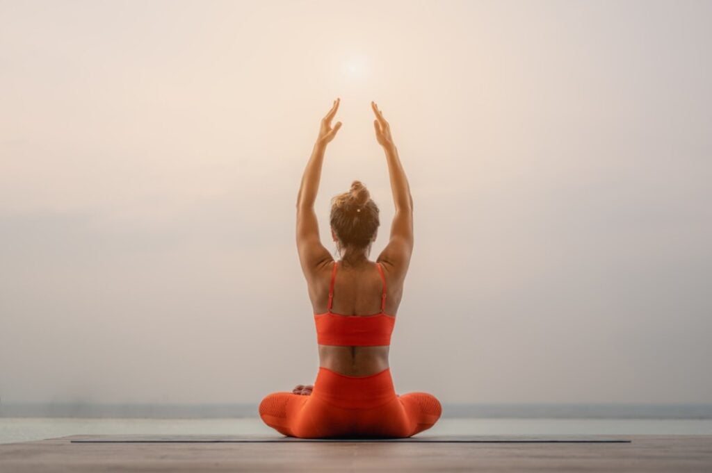person doing I am sacral chakra affirmations in meditation